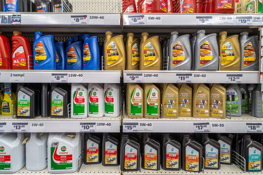 Italy - November 15, 2023: engine motor car oil in packages of various types and brands such as Castrol, Petronas Selenia and Eni displayed on shelves for sale in DIY store