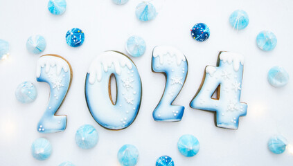 2024 Happy New Year! Numbers made from gingerbread cookies covered with blue glaze. A delicious...