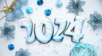 2024 Happy New Year! Numbers made from gingerbread cookies covered with blue glaze. A delicious...