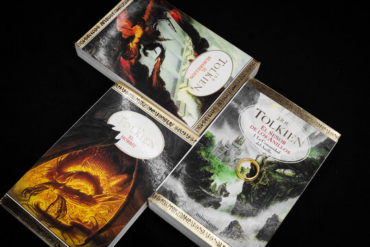 the simarillion the hobbit and the lord of the rings text books in spanish written by J R R Tolkien over black background