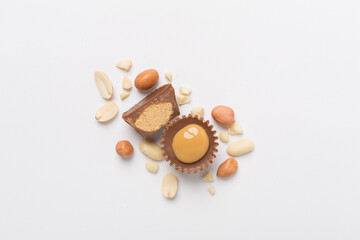 Tasty chocolate peanut butter cups on color background, top view
