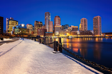 Boston skyline, financial district and harbor at winter night, Boston, MA, USA