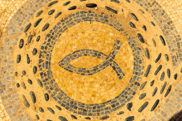Ancient mosiac of a fish symbol found on Mediterranean island of Ibiza. Holiday destination. Graphic resource.