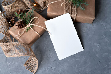 Empty white paper card template, crafted gift boxes decorated in rustic country style, on gray...