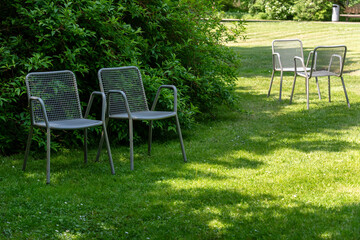 Metal chairs in spring garden. Metal garden furniture for picnics and birdwatching