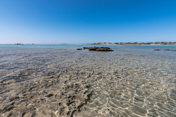 Beautiful view of Elafonisi Beach, Chania. The amazing pink beach of Crete. Elafonisi island is like paradise on earth with wonderful beach with pink coral and turquoise waters.