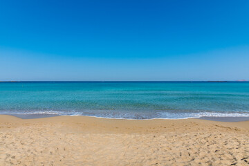 Fototapeta na wymiar View of the sea in the Island with sandy beach, cloudless and clear water. Tropical colours, peace and tranquillity. Turquoise sea. Falasarna beach, Crete island, Greece.
