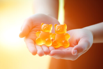 Immuno-gummy bears with orange flavor for children in children's hands. Dietary supplement