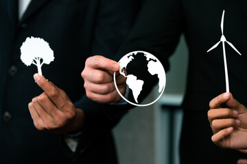 Group of business people holding alternative net zero energy icon for greener sustainable Earth...