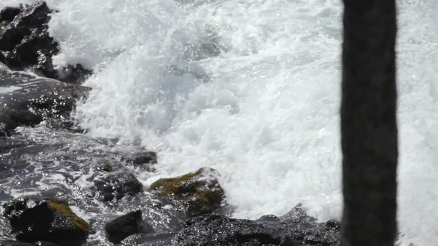 slow motion waves crashing between lava rocks maui hawaii