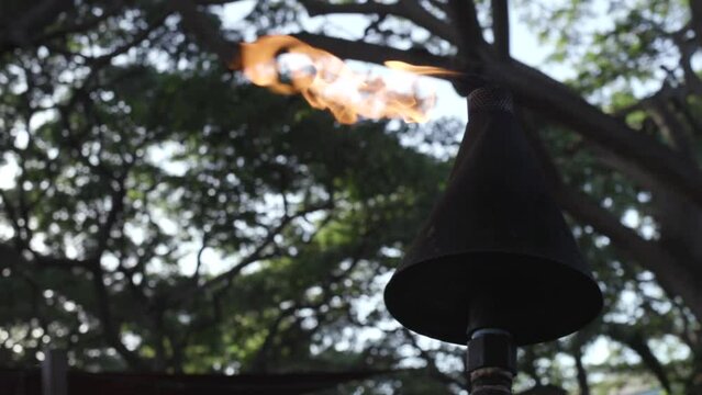 Tiki torch burning slow motion Maui