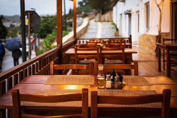 Wooden table and chairs. Outdoor cafe with wooden tables. Natural tables near a street cafe on a summer day
