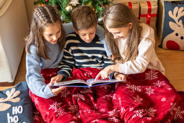 In A Cozy Corner Of The House, Three 8-Year-Old Children Enjoy Shared Reading, Letting The Magic Of Stories Envelop Them In Happiness.