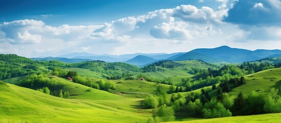 Obraz premium Beautiful Green hills with mountains landscape with blue sky view. AI generated