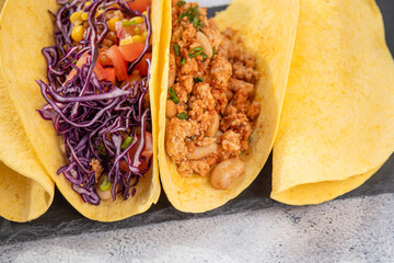 Birria Tacos, a Mexican culinary delight, feature round tortillas stuffed with a savory blend of meat, beans, and greens. Purple cabbage and corn are added, a homemade taco   - obrazy, fototapety, plakaty