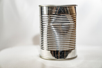 A dented tin can. Ribbed structure.