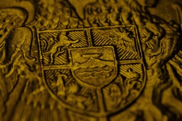 an image of a gold coat of arms with lion and eagle