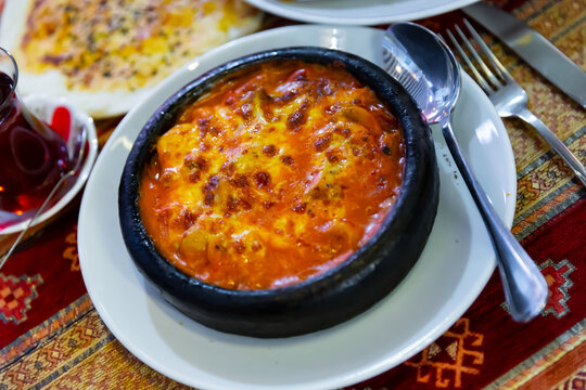 Tasty saute of meat and vegetable with appetizing browned melted cheese crust served in traditional Turkish restaurant