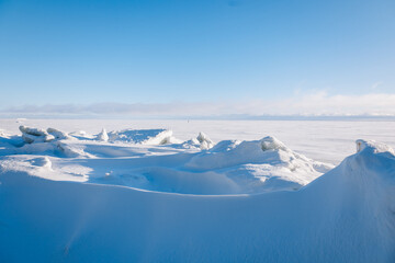 Beautiful winter landscape. Field of white snow and ice on horizon. Light and airy feel and light color palette. High quality photo