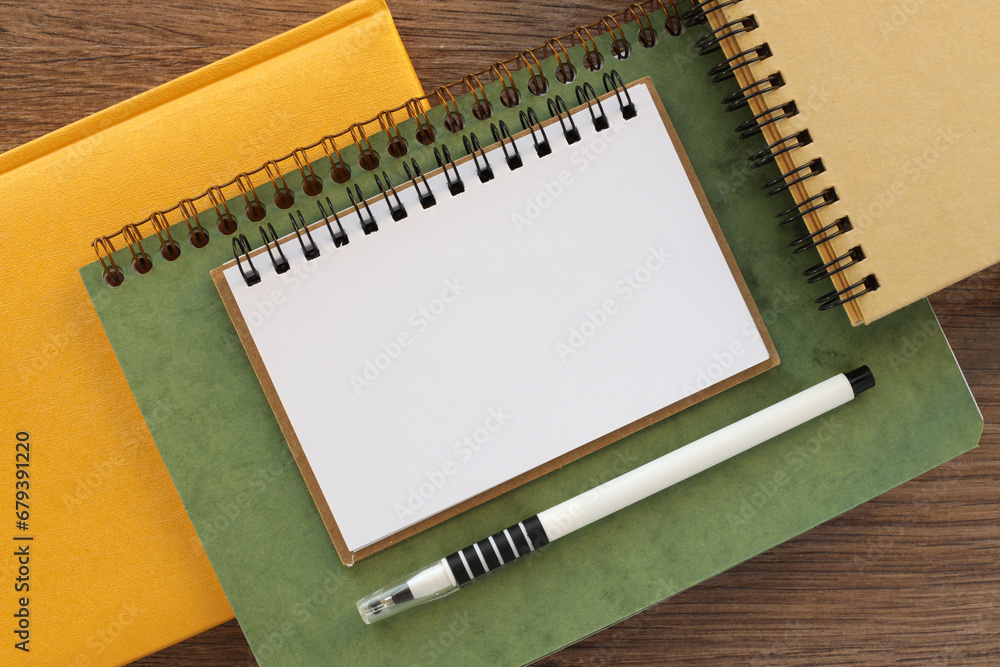 Poster different notebooks and page. blank notepad page for entering text in the middle. top view, flat lay