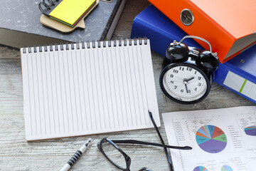 financial charts opening notepad. Top view with copy space, flat lay.