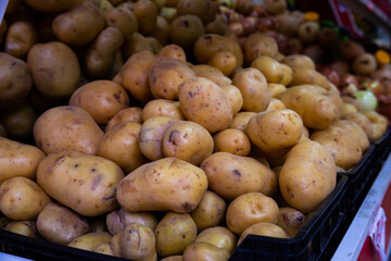 Potatoes in crates and baskets at the grocery store