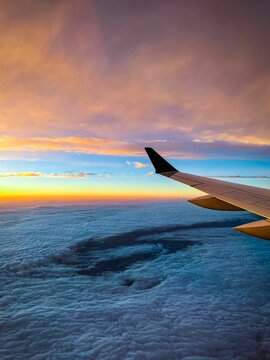 Aerial View From An Airplane Window Of A Vibrant Sunset Sky