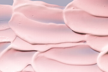 Obraz na płótnie Canvas Cosmetic cream texture pink colored background