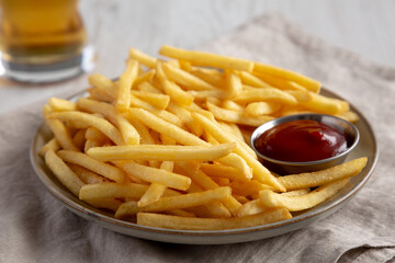 Homemade French Fries with Ketchup and Cold Beer, low angle view.