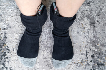 woman wears battery powered heated socks for cold winter