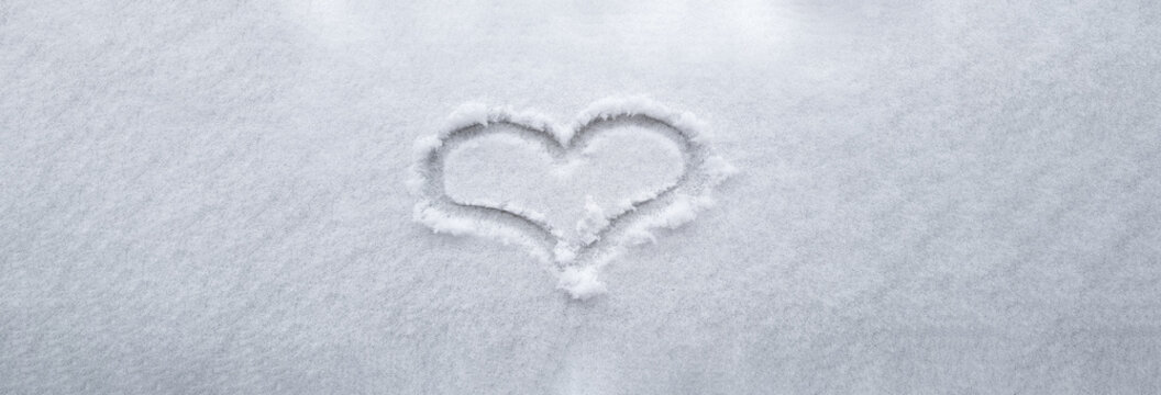 Banner picture, heart hand written on the snow, winter love, happy valentines day