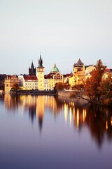 Fototapeta na wymiar Beautiful medieval buildings of Prague illuminated in the waters