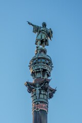 Monumental statue of Christopher Columbus in Barcelona against a beautiful, clear blue sky backdrop