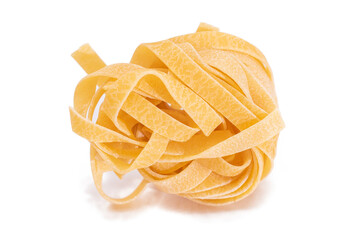 One Classic Italian Raw Egg Fettuccine - Isolated on White Background. Dry Twisted Uncooked Pasta. Italian Culture and Cuisine. Raw Golden Macaroni Pattern - Isolation