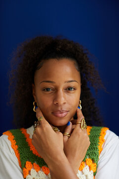 Portrait of a biracial woman with curly natural hair posing with manicure and stylish rings. Concept of diverse, stylish, fashion and beauty and jewelry