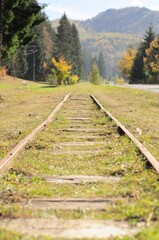 Obraz premium Scenic view of a railway track winding through the countryside, with majestic mountains
