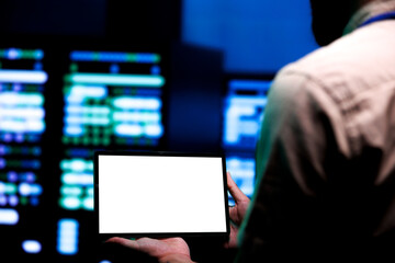 Adept repairman conducting routine auditing of data center server racks using mock up tablet to optimize dataset processing, prevent system damages and ensure uninterrupted computing power