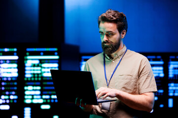 Specialist doing maintenance in server farm providing secure, scalable, and failsafe infrastructure...