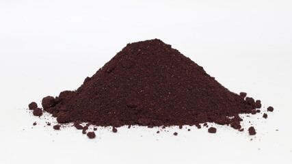 Aronia berries powder spilled in a small pile.