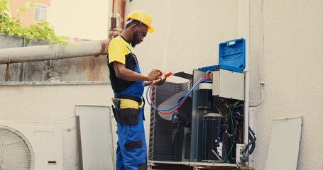 Skillful serviceman calibrating set of barometer meters during comissioned condenser analysis....