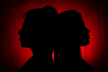silhouette of two women confronting each other - obrazy, fototapety, plakaty