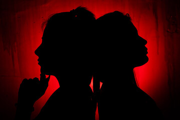 silhouette of two opposite women