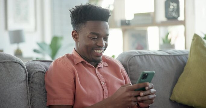 Man, couch and texting with smile, home and relaxing for social media apps, scrolling and laughing. Mobile apps, games and scrolling feed for posts, videos and memes in living room, happy and online