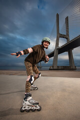 Roller skating teen in outdoors rollerblading on inline skates. Caucasian young girl in outdoor...