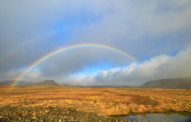 rainbow over field in the Reykjavik Peninsula, Iceland