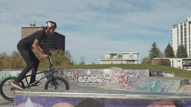 Bmx rider does a 180 bar spin in slow motion. 300fps