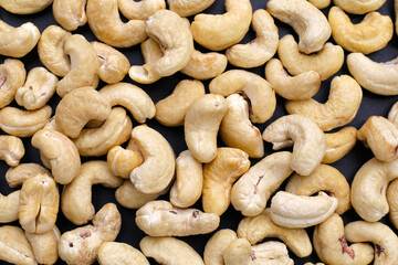 Cashew nuts on dark background.