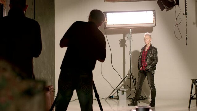 Woman is engaging in a professional photoshoot, creating content for social media promotion. Visually cohesive and compelling feed that aligns with her personal brand or message she intends to convey.