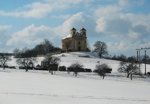 Church of St. Katerina in the Chotec countryside near Prague. Czechia. Cultural monument under reconstruction, winter snowy scenery. Catholic church from the 16th century.