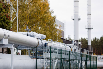 pipelines close-up on the background of an industrial plant and gray sky